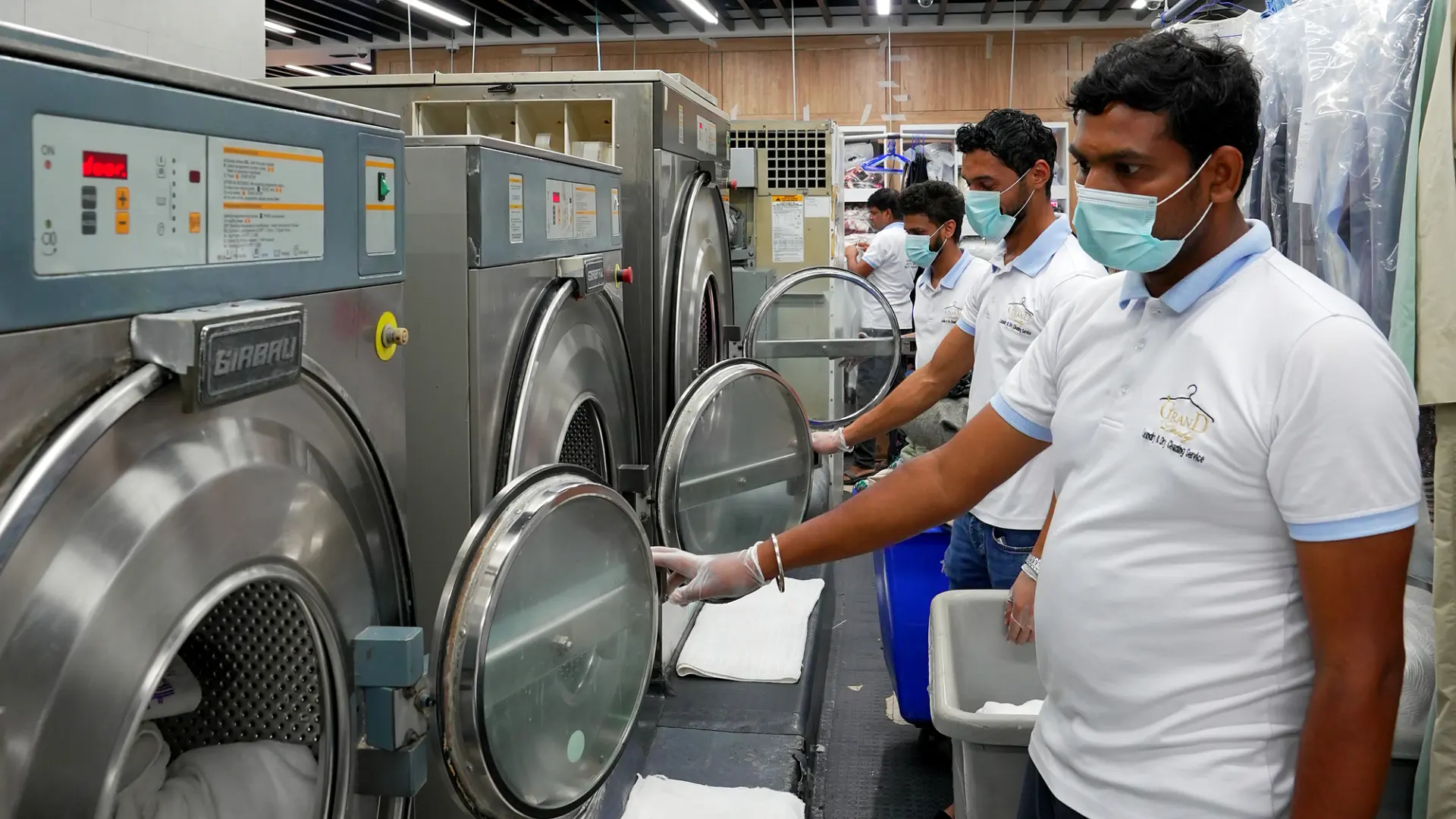 The Grand Laundry team at the washing machines in their Abu Dhabi facility