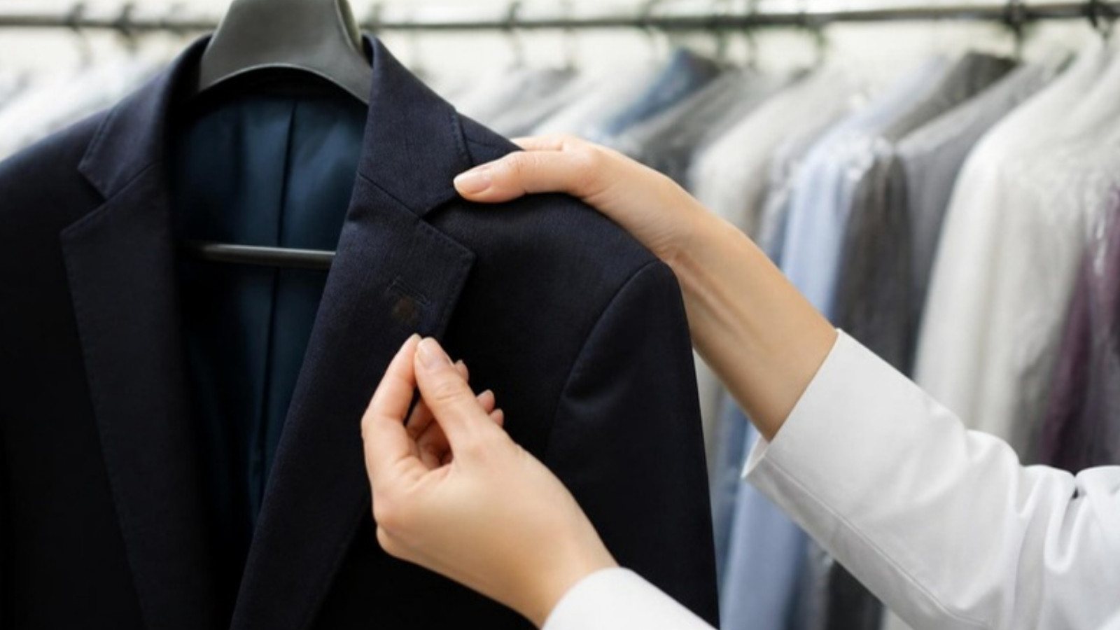 Checking a stain on a blazer before dry cleaning