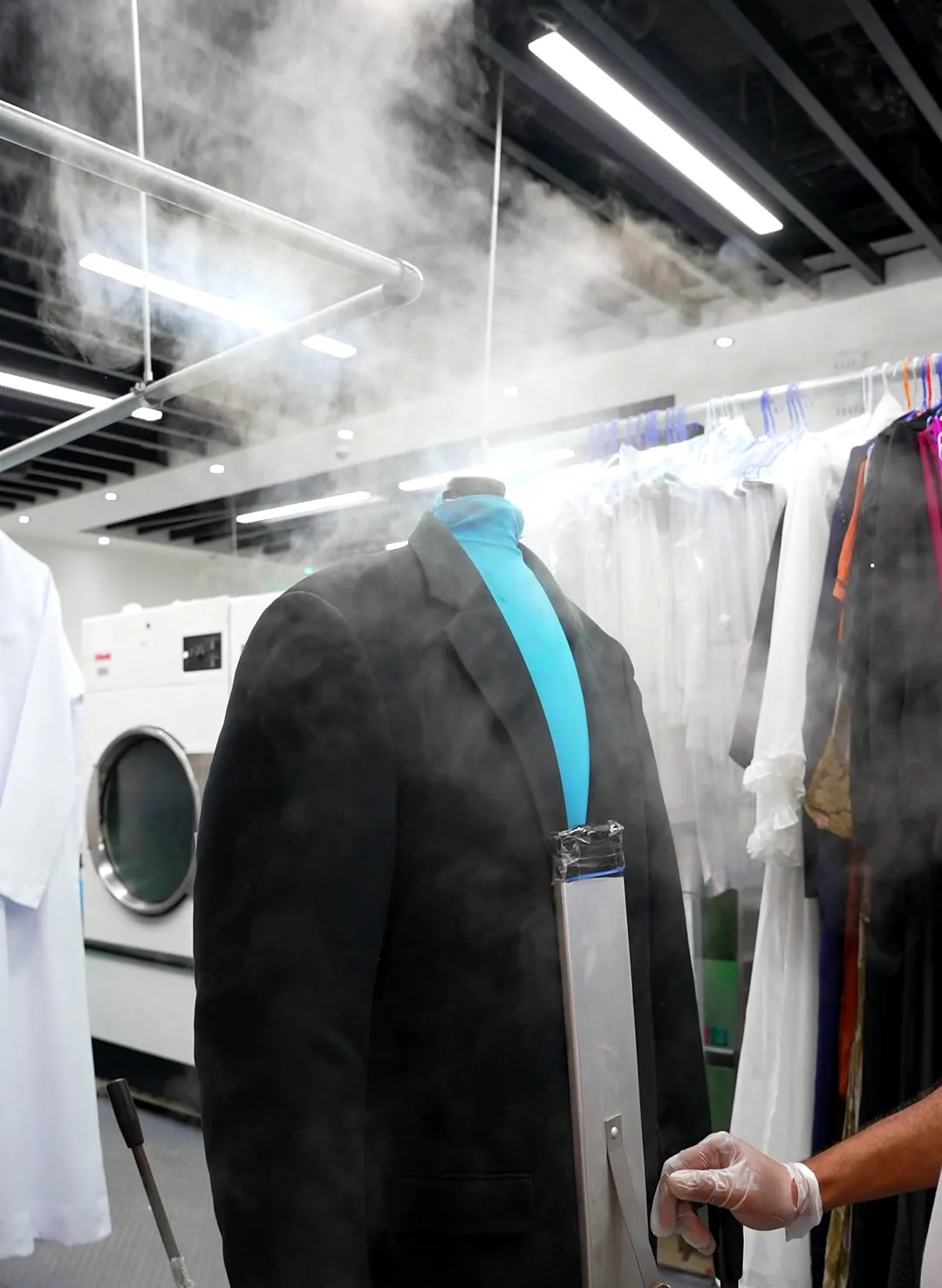 Jacket being steam finished after dry cleaning at Grand Laundry, Abu Dhabi