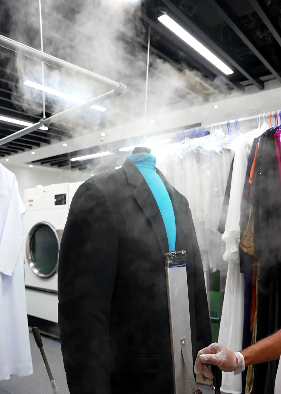 Garment being steam finished at Grand Laundry, Abu Dhabi